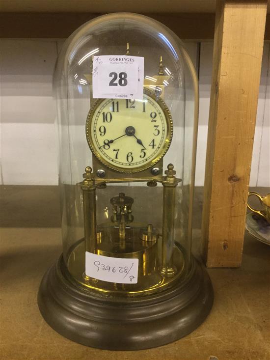 Brass skeleton clock under dome(-)